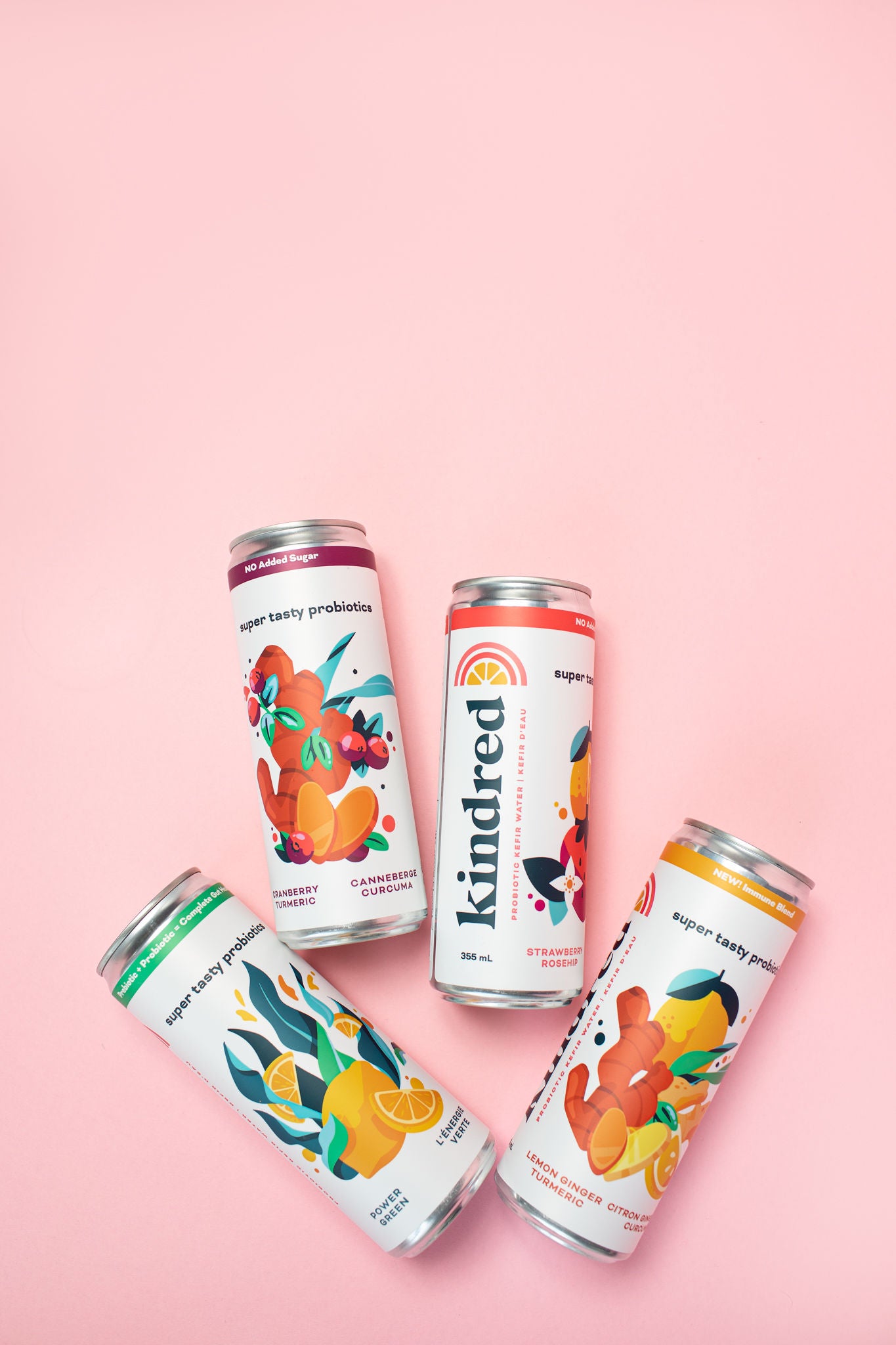 Kefir Water Cans in 4 flavours from left to right - Power Green, Cranberry Turmeric, Strawberry Rosehip, Lemon Ginger Turmeric